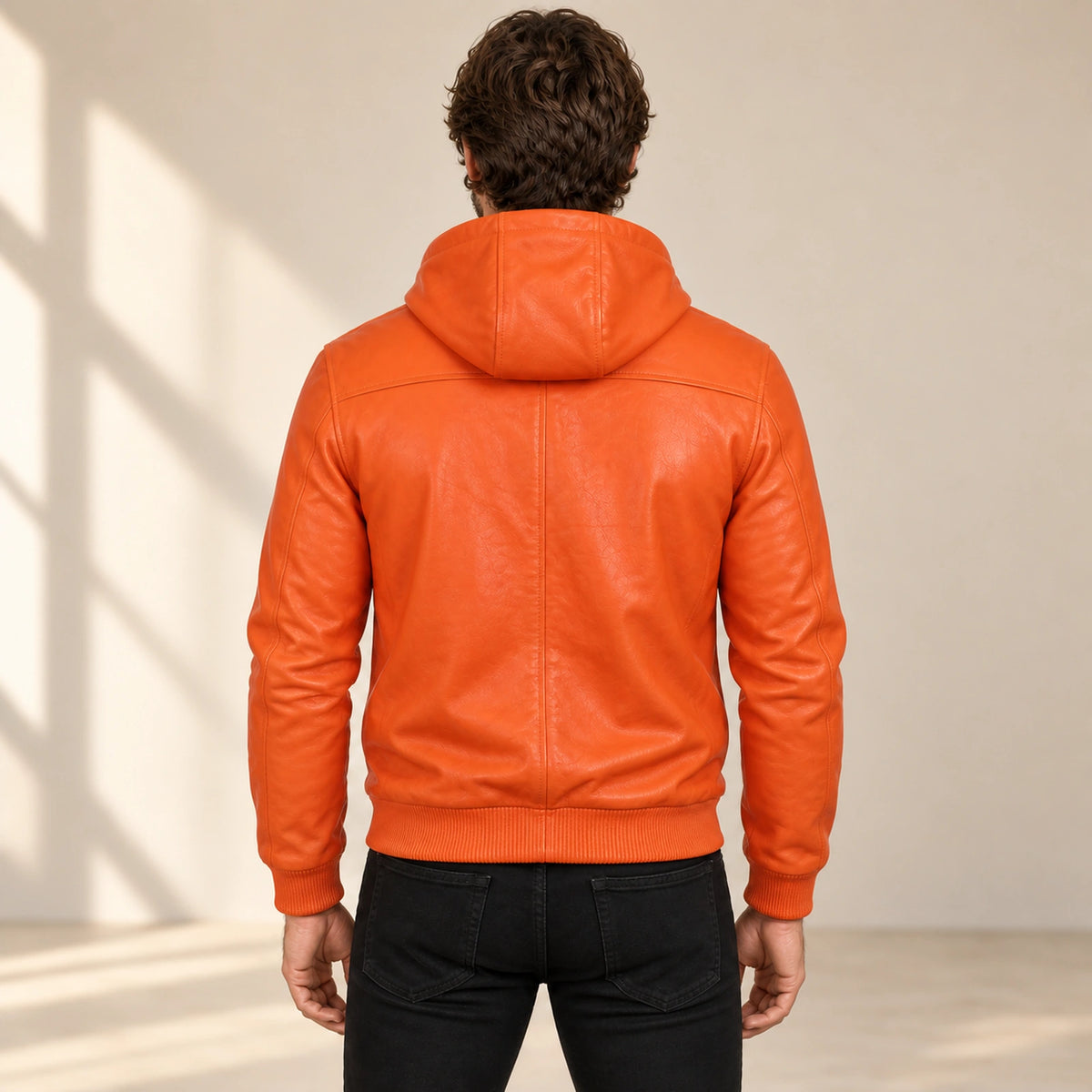 Male model wearing the Northwick Orange genuine leather zip hoodie, back view.