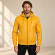 Male model wearing the Northwick Yellow genuine leather zip hoodie, front view.