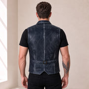 Male model wearing the Ravenscroft Navy vintage waxed lambskin leather waistcoat, rear view with waist adjuster.
