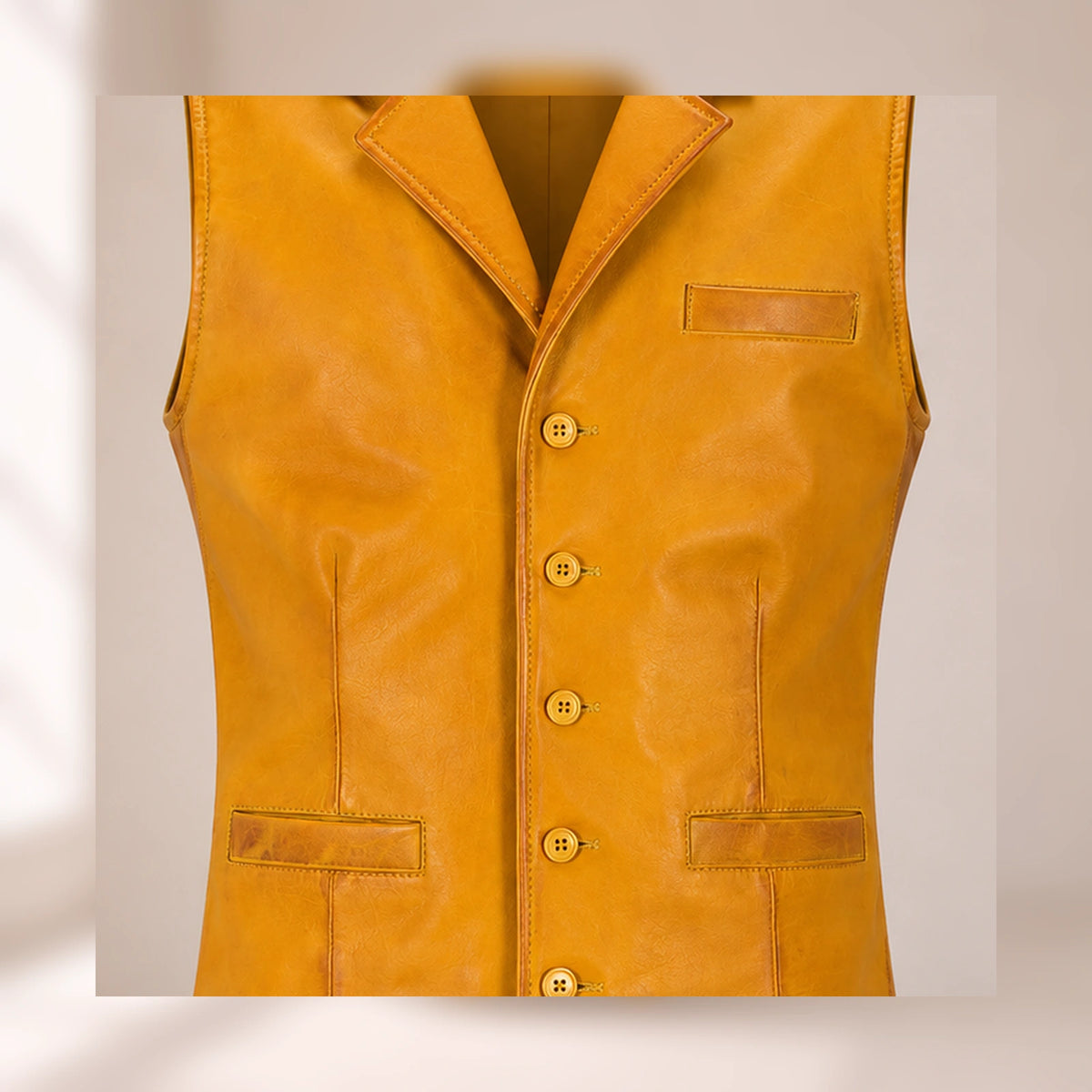 Close-up of the Ravenscroft Yellow waxed lambskin texture, notch lapel, buttons and welt pockets.