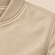Close-up of beige bomber jacket leather grain and seam stitching