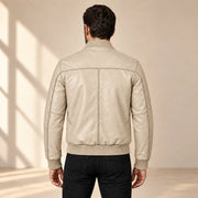 Male model wearing the beige sheepskin leather MA-1 bomber jacket, back view