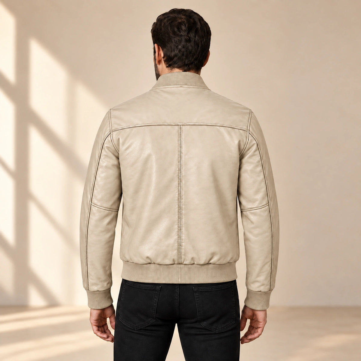 Male model wearing the beige sheepskin leather MA-1 bomber jacket, back view