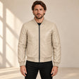 Male model wearing the beige sheepskin leather MA-1 bomber jacket, front view