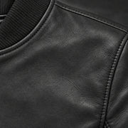 Close-up of black bomber jacket leather grain and seam stitching