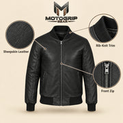 Black sheepskin leather MA-1 bomber jacket showing leather texture, ribbed trim and front zipper