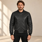 Male model wearing the black sheepskin leather MA-1 bomber jacket, front view