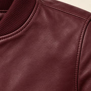 Close-up of burgundy bomber jacket leather grain and seam stitching