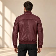 Male model wearing the burgundy sheepskin leather MA-1 bomber jacket, back view