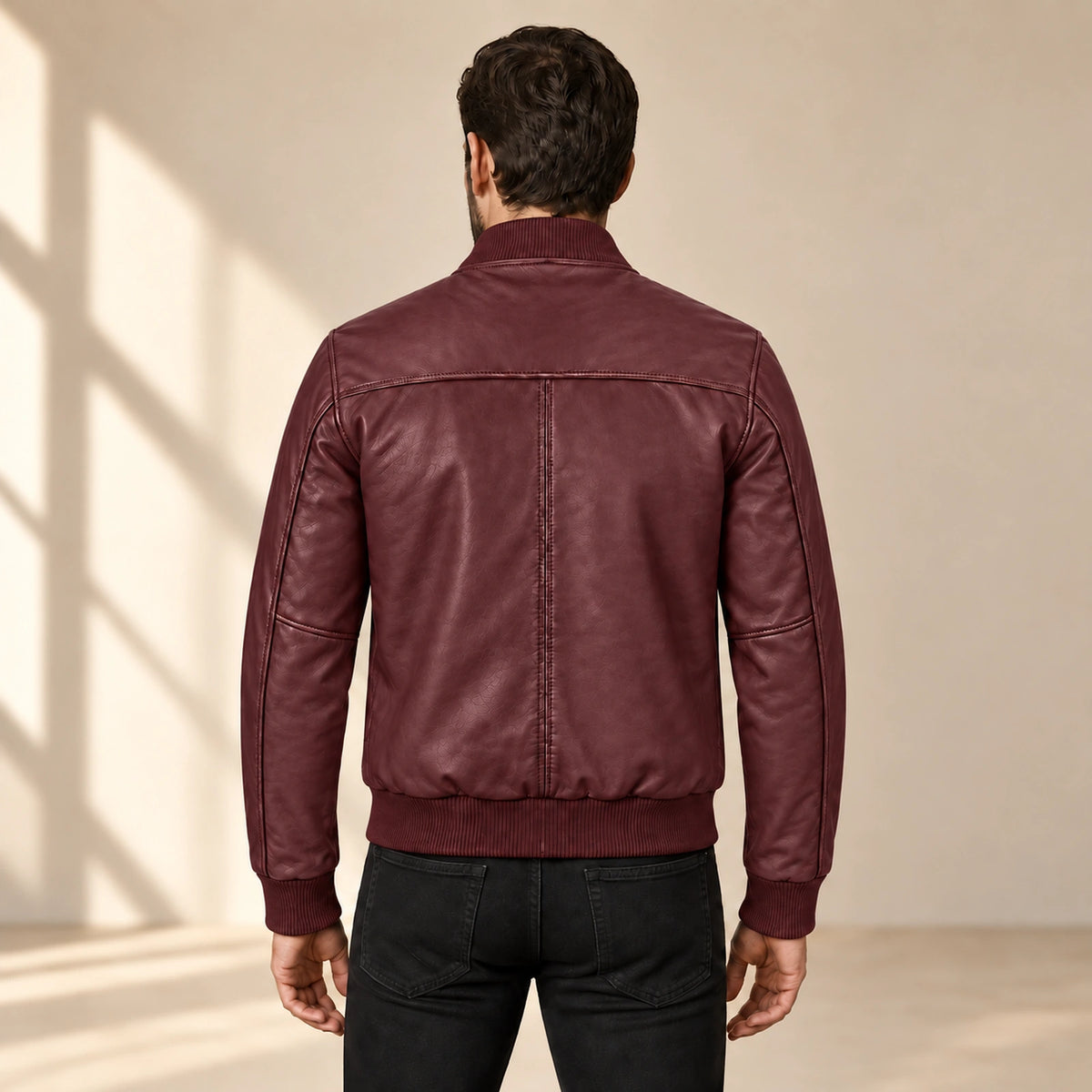Male model wearing the burgundy sheepskin leather MA-1 bomber jacket, back view