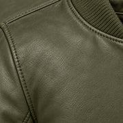 Close-up of green bomber jacket leather grain and seam stitching