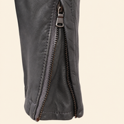 Grey men's snap-collar lambskin biker jacket, close up.
