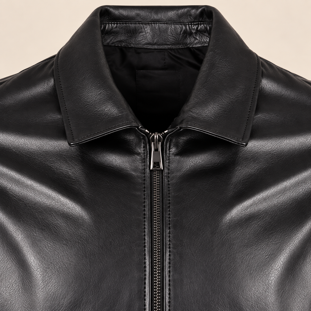Close-up of the leather texture and construction of the Tarnwick men's black vintage leather trench coat.