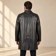 Rear view worn by a male model of the Tarnwick men's black vintage leather trench coat.
