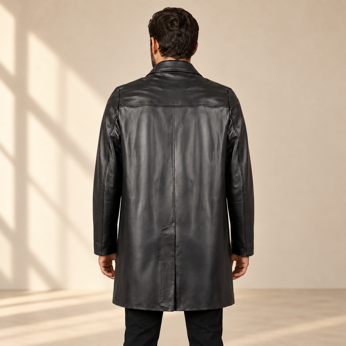 Rear view worn by a male model of the Tarnwick men's black vintage leather trench coat.