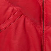 Close-up of leather texture of the MOTOGRIP red lambskin leather puffer jacket, showing its red body with tonal V stitching.